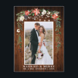 Watercolor Winter Floral Wood Married and Merry Postcard<br><div class="desc">Rustic Wood Elegant Watercolor Winter Floral Wood Newlywed Photo Married & Merry Christmas Postcard includes beautiful watercolor red poinsettias,  botanical greenery,  winter foliage,  holly berries,  white roses,  cotton,  pine cones and blue berries.  Rustic Country Wood and String Lights.</div>