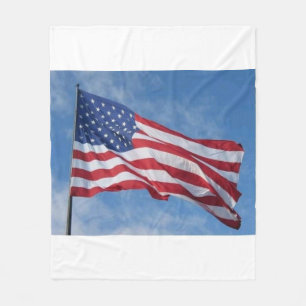 Waving American Flag Against Blue Sky Fleece Blanket
