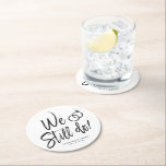 We Still Do | Anniversary Party Script Lettering Round Paper Coaster<br><div class="desc">A fun and unique script lettered paper coaster tailored specifically to your anniversary party. It features the words "We still do" with wedding rings resting about it. Underneath this are the names of the bride and groom and the wedding date.</div>