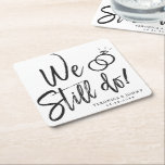 We Still Do Anniversary | Vow Renewal Square Paper Coaster<br><div class="desc">A fun and unique script lettered paper coaster tailored specifically to your Anniversary party or wedding vow renewal.  It features the words "We still do" with wedding rings resting above it.</div>