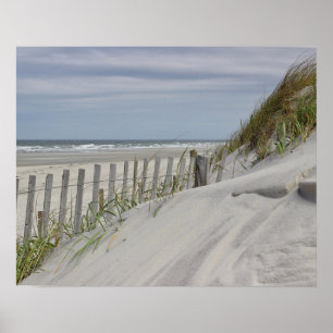 Weathered fence and sand dunes at the beach poster