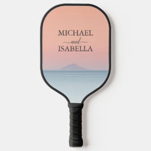 Wedding by the sea under peachy sky sunset pickleball paddle