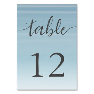 Wedding by the sea under peachy sky sunset table number