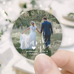 Wedding Photo & Elegant White Script Thank You Classic Round Sticker<br><div class="desc">Add an elegant personalised touch to wedding thank you cards and reception party favours with these custom photo round stickers / envelope seals. Picture, couple's names, date and heart are all simple to customise. (IMAGE PLACEMENT TIP: An easy way to centre a photo exactly how you want is to crop...</div>
