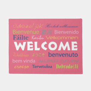 Welcome in Many Languages Pink Background Doormat