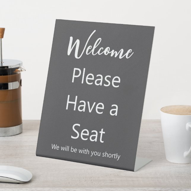Welcome Please Have a Seat Grey and White Text Pedestal Sign (In SItu)