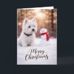 West Highland White Terrier Christmas Snowman Holiday Card<br><div class="desc">A charming winter holiday scene featuring a West Highland White Terrier sitting in fresh snow beside a cheerful little snowman wrapped in a bright red scarf. Soft golden winter light and gently falling snow create a peaceful seasonal moment that highlights the bright white coat and spirited personality Westies are known...</div>