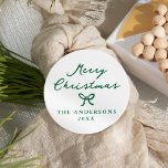 Whimsical Hand-Drawn Green Bow Christmas Classic Round Sticker<br><div class="desc">Elegant and festive, these Christmas stickers feature “Merry Christmas” in handwritten green script on a white background. A hand-drawn green bow sits beneath the greeting, separating it from your name and year for a simple yet charming look. Ideal for sealing envelopes, holiday party favours, or giving packages a personalised holiday...</div>