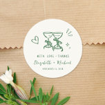 Whimsical Hand Drawn Green Cream Wedding Thank You Classic Round Sticker<br><div class="desc">Trendy light cream wedding stickers for your party favors and thank you cards featuring whimsical hand-drawn green illustrations of a heart,  stars and wine glasses,  and "with love   thanks" and the names of the bride and groom in fun and playful green script and lettering.</div>