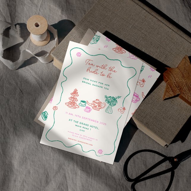 Whimsical Hand Drawn Tea Party Bridal Shower Invitation (hand drawn bridal shower tea party invitation with hand written font resting on a book.)