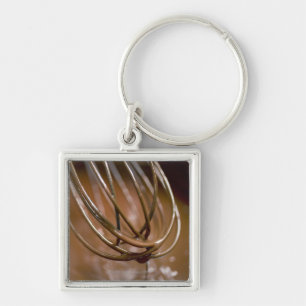 Whisking the chocolate in a saucepan to melt the key ring