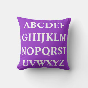 WHITE ALPHABET on Bright purple pillow