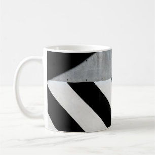 White and black diagonal striped paint on wall coffee mug
