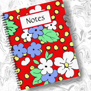 White and blue flowers on red spiral notebook