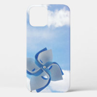 White and blue handheld windmill under cloudy skie