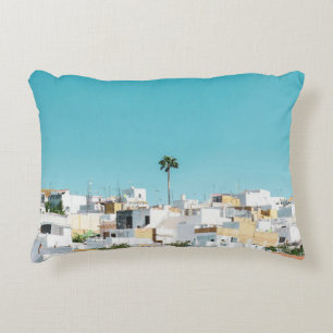 White and brown concrete houses under blue sky in  decorative cushion