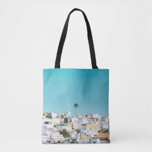 White and brown concrete houses under blue sky in tote bag