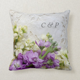 White and purple flowers on old lace cushion