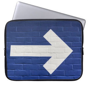 White arrow painted on brick wall laptop sleeve