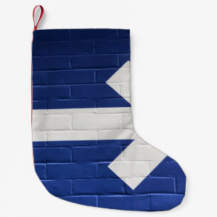 White arrow painted on brick wall small christmas stocking