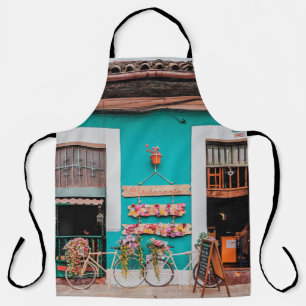 WHITE BICYCLE PARKED BESIDE TEAL PAINTED CONCRETE  APRON