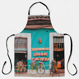 WHITE BICYCLE PARKED BESIDE TEAL PAINTED CONCRETE APRON