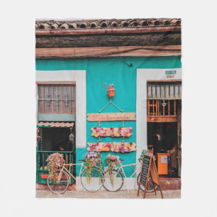 WHITE BICYCLE PARKED BESIDE TEAL PAINTED CONCRETE  FLEECE BLANKET