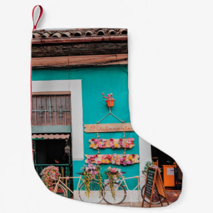 WHITE BICYCLE PARKED BESIDE TEAL PAINTED CONCRETE SMALL CHRISTMAS STOCKING