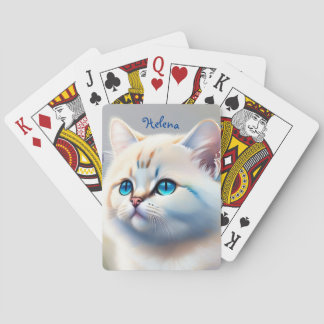 white cat with blue eyes playing cards