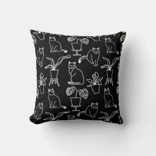 White cats on black cushion