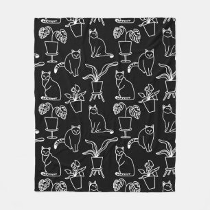 White cats on black fleece blanket