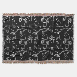 White cats on black throw blanket