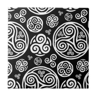White celtic triskels on black ceramic tile