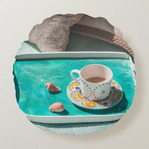 White ceramic mug on white serving tray round cushion