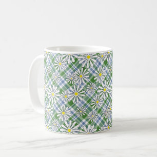 White chamomile flowers on a green blue chequered  coffee mug