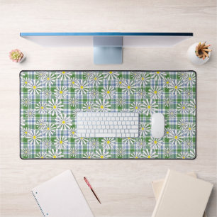 White chamomile flowers on a green blue chequered  desk mat