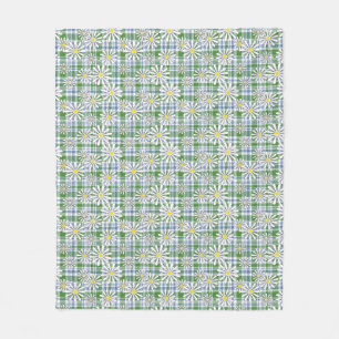 White chamomile flowers on a green blue chequered  fleece blanket