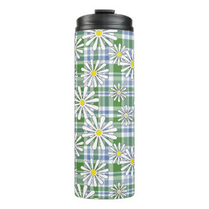 White chamomile flowers on a green blue chequered thermal tumbler