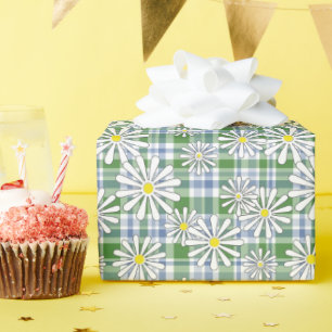 White chamomile flowers on a green blue chequered wrapping paper