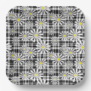 White chamomile flowers on black white chequered b paper plate