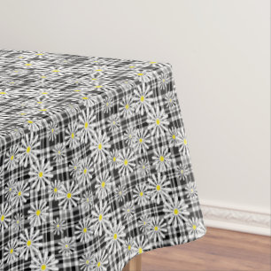 White chamomile flowers on black white chequered b tablecloth
