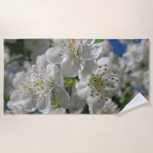 white cherry blossom in spring against a blue sky beach towel