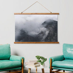 White clouds over the dark rocky mountains hanging tapestry
