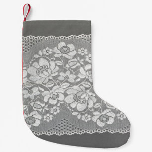 White colour straight strip of lace fabric on grey small christmas stocking