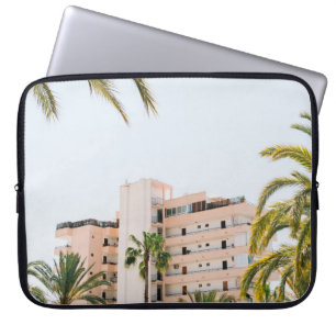 WHITE CONCRETE BUILDING BESIDE GREEN PALM TREE UND LAPTOP SLEEVE