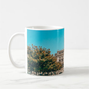 WHITE CONCRETE BUILDING UNDER BLUE SKY DURING DAYT COFFEE MUG