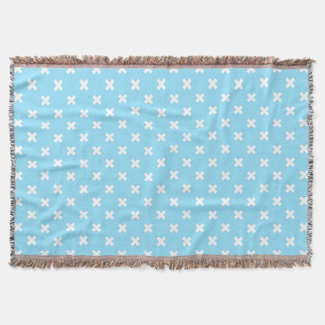 White cross stitches on baby blue throw blanket (Front)