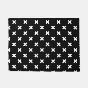 White cross stitches on black doormat