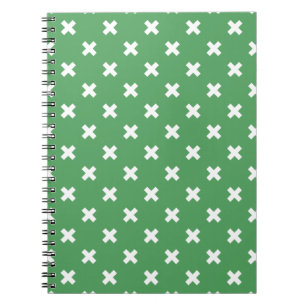 White cross stitches on green notebook