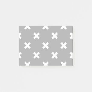 White cross stitches on grey post-it notes